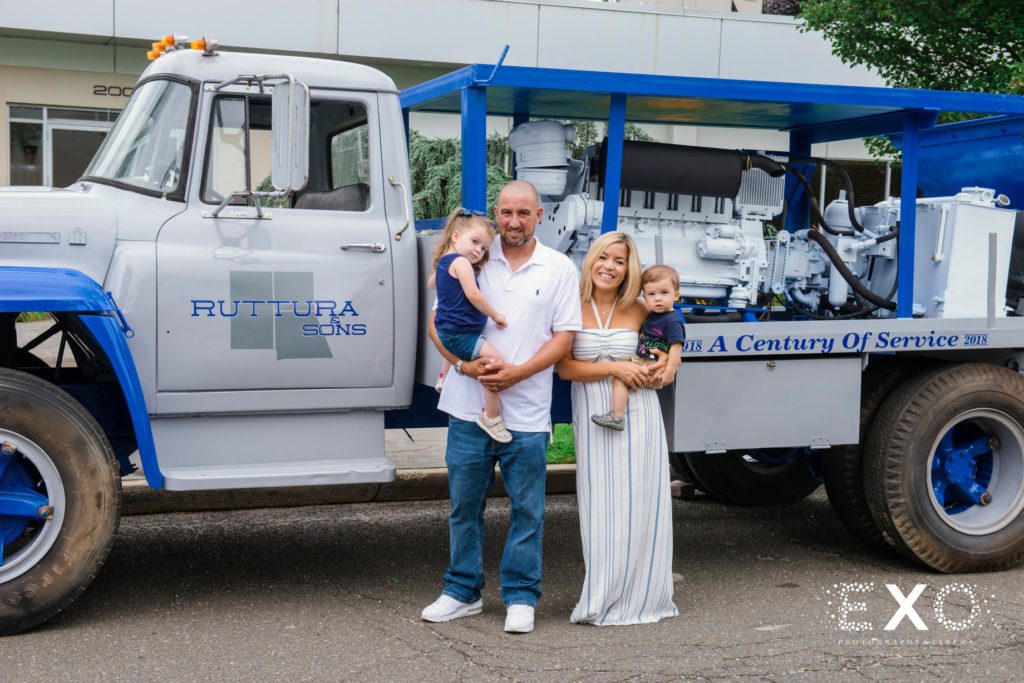 family in front of ruttura and sons truck