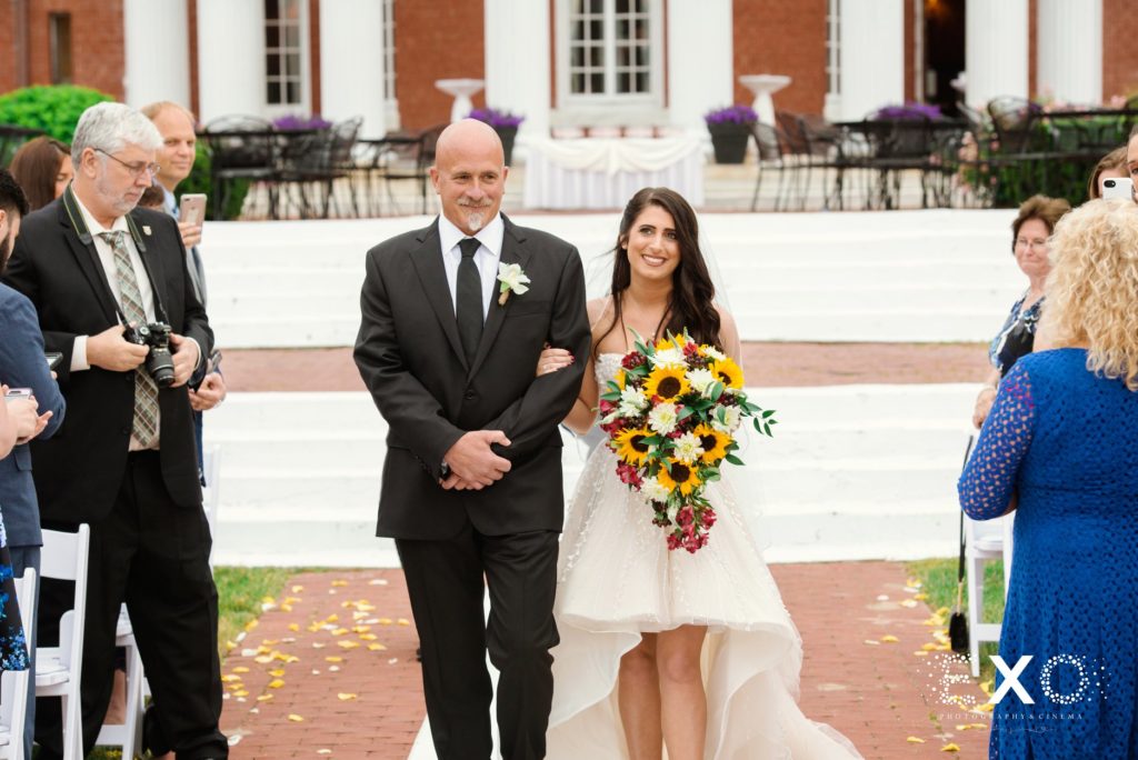 bride's father walking her down the aisle at Bourne Mansion