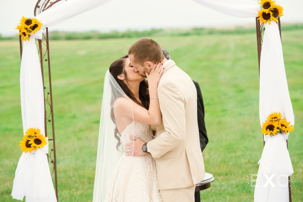 bride and groom kissing for the first time at Bourne Mansion