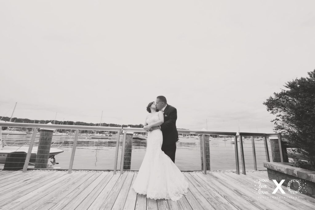 bride and groom kissing on dock at Harbor Club at Prime
