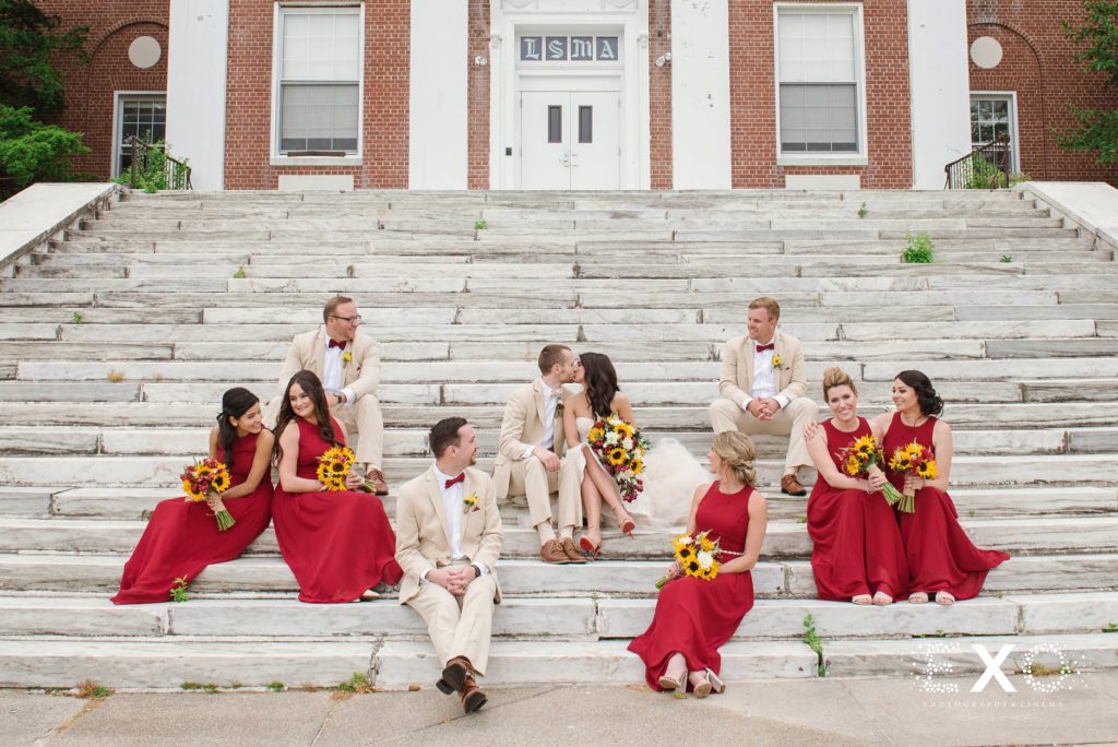 bride and groom with bridal party on steps at Bourne Mansion
