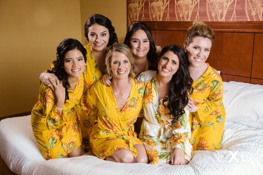 bride and bridesmaids in robes smiling