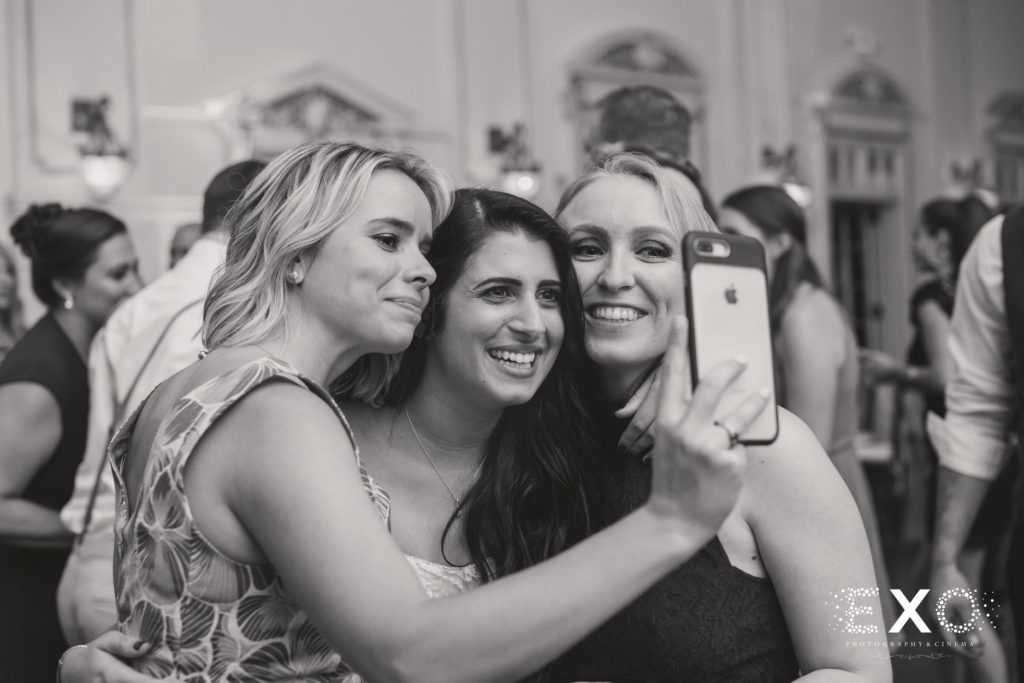 bride taking a selfie with guests at Bourne Mansion