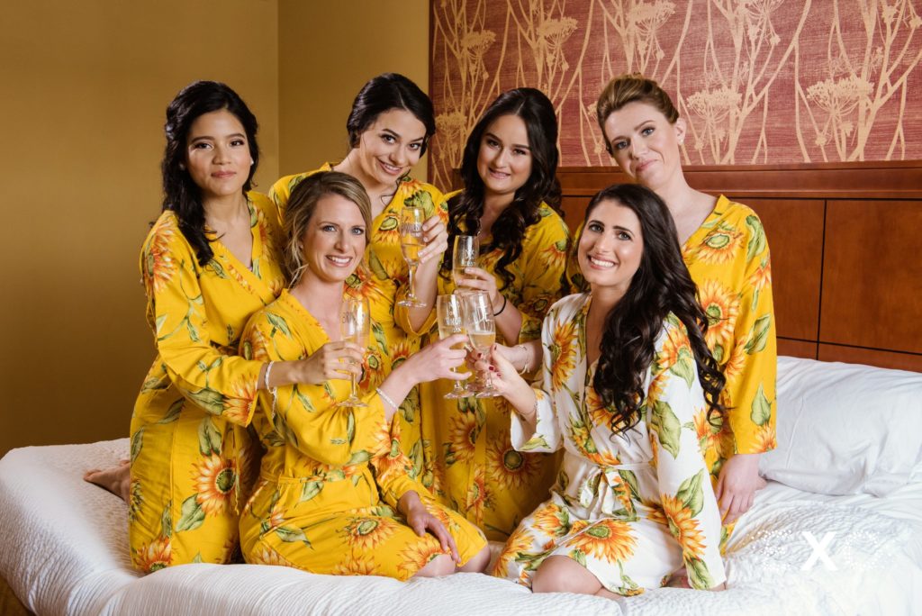 bride with her bridesmaids drinking at Bourne Mansion