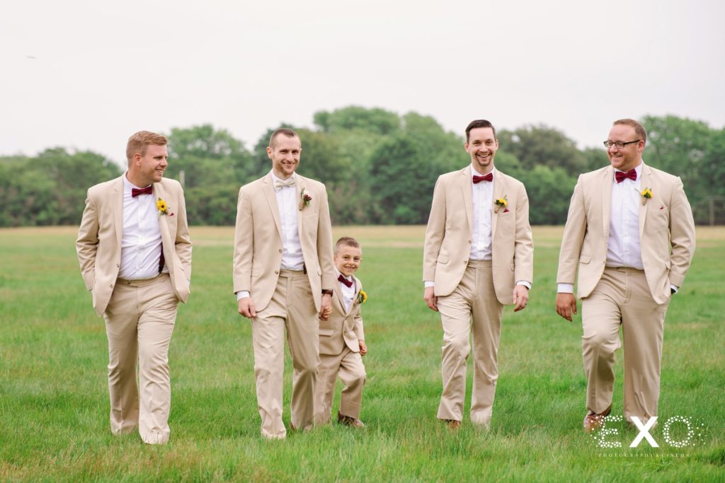 groomsmen in a field at Bourne Mansion