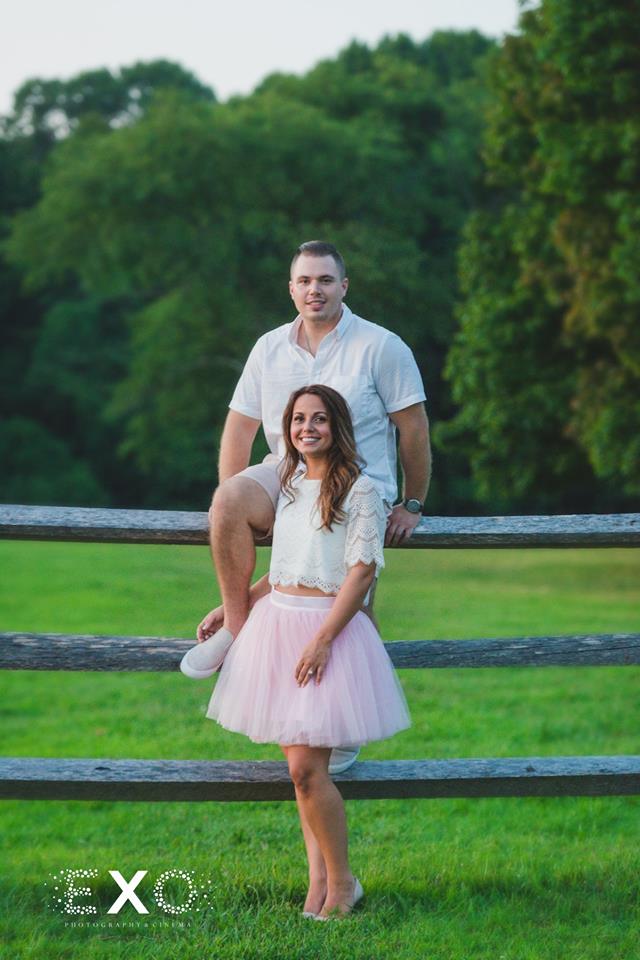couple posing on fence at Caumsett State Historic Park Preserve
