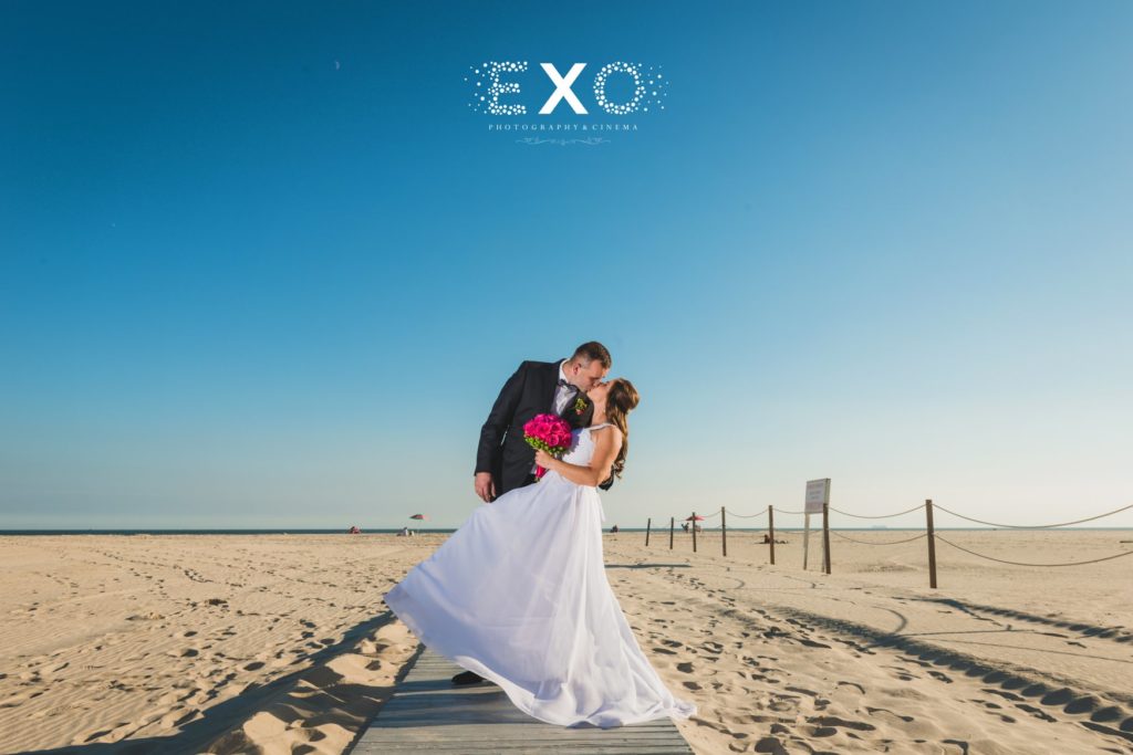 bride and groom kissing on the beach at Sunny Atlantic Beach Club