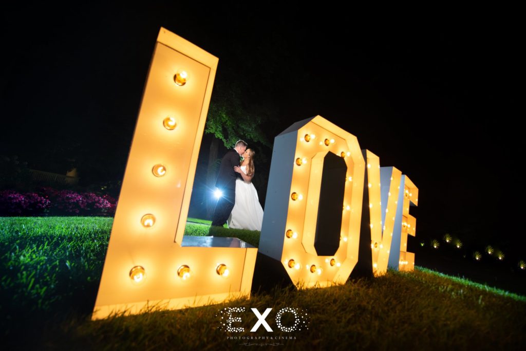 bride and groom with love sign