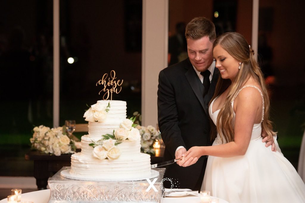 bride and groom cutting into their wedding cake at Stonebridge Country Club
