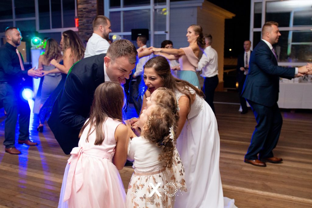 bride and groom dancing with kids at Sunny Atlantic Beach Club