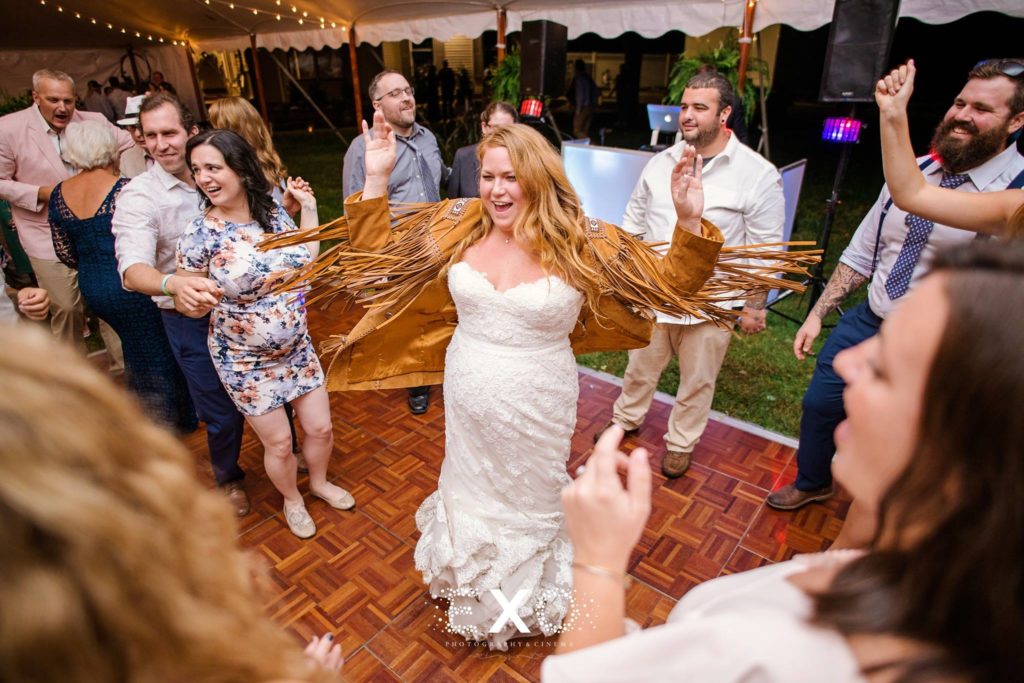 bride dancing with cool coat at their private residence