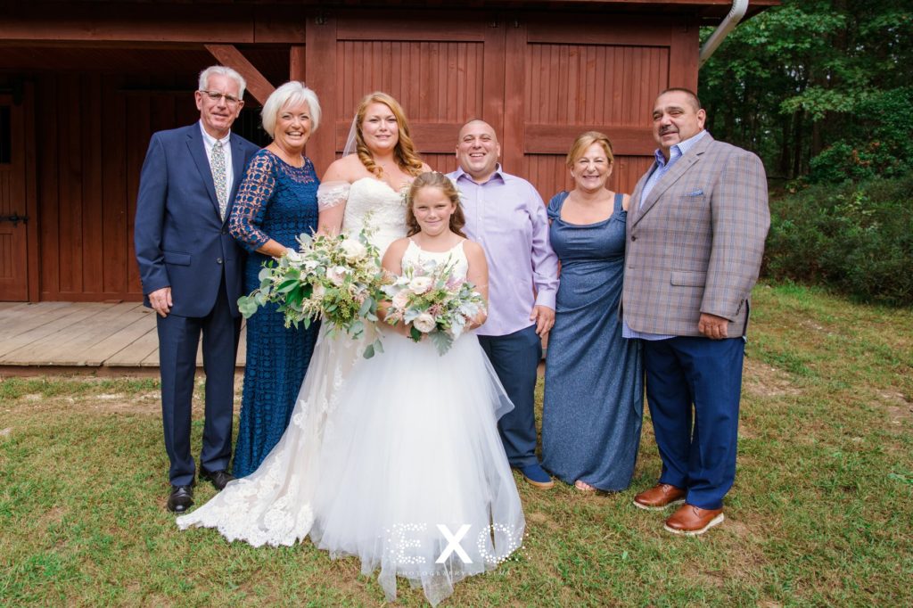 bride and groom with their immediate family at their private residence