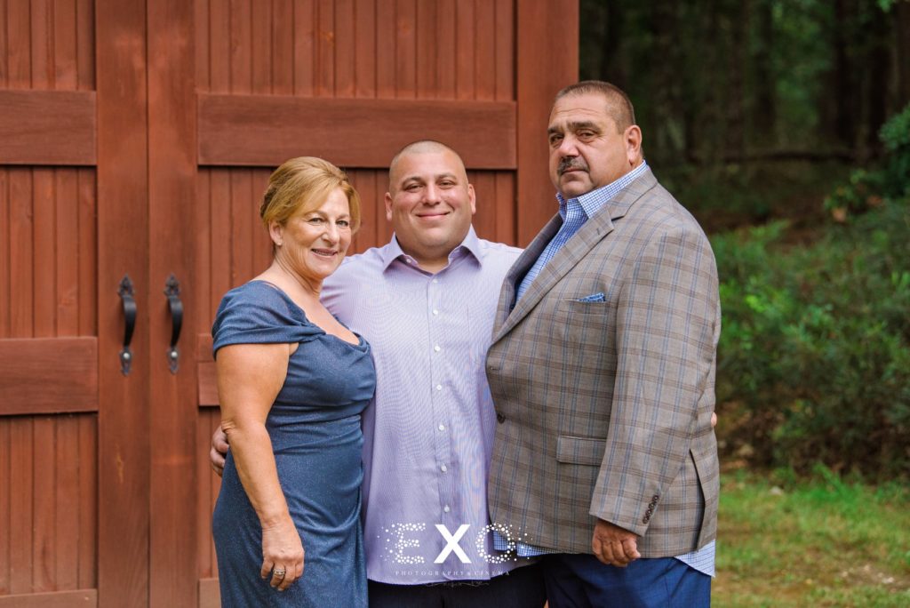 groom with his parents at their private residence
