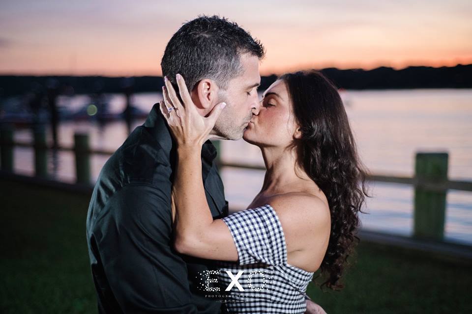 couple kissing during sunset at Northport Village