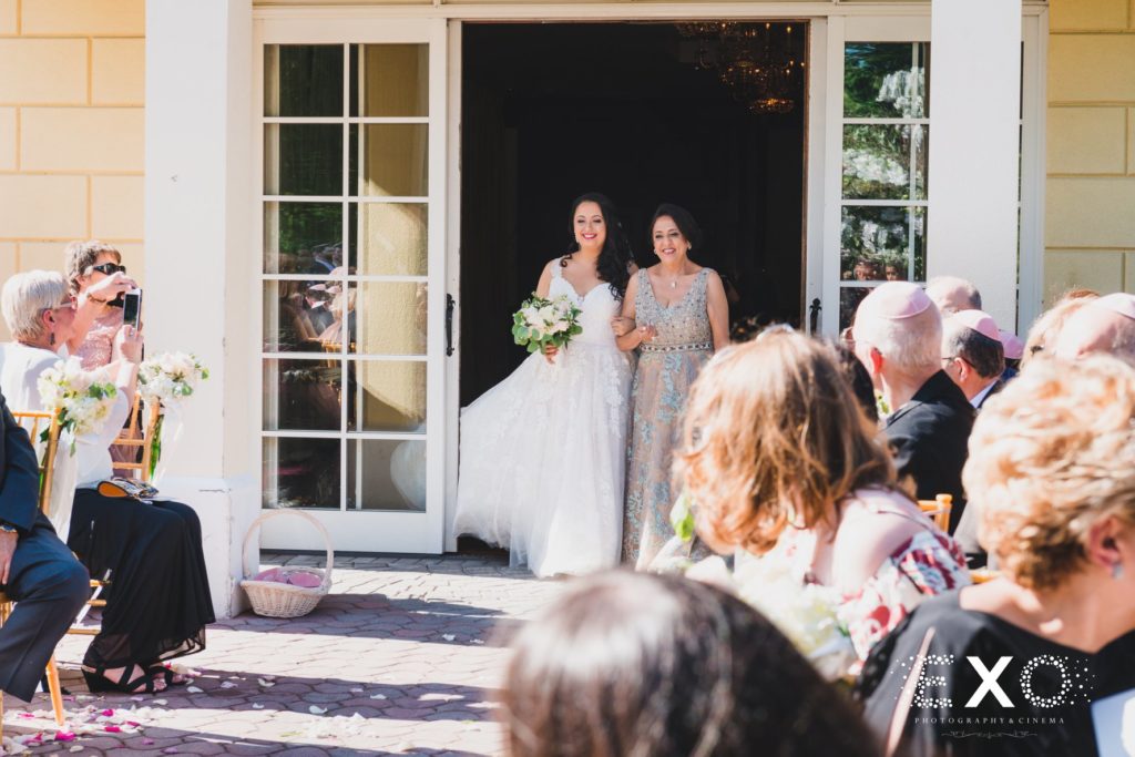 bride and mother walking down the aisle at Mansion at Oyster Bay