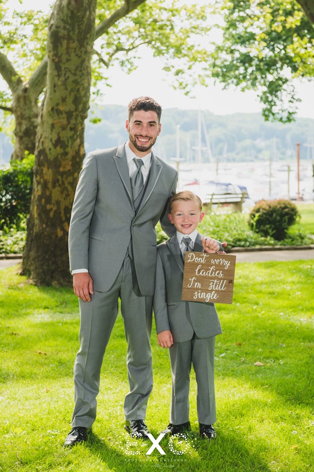 groom with kid holding sign at Larkfield