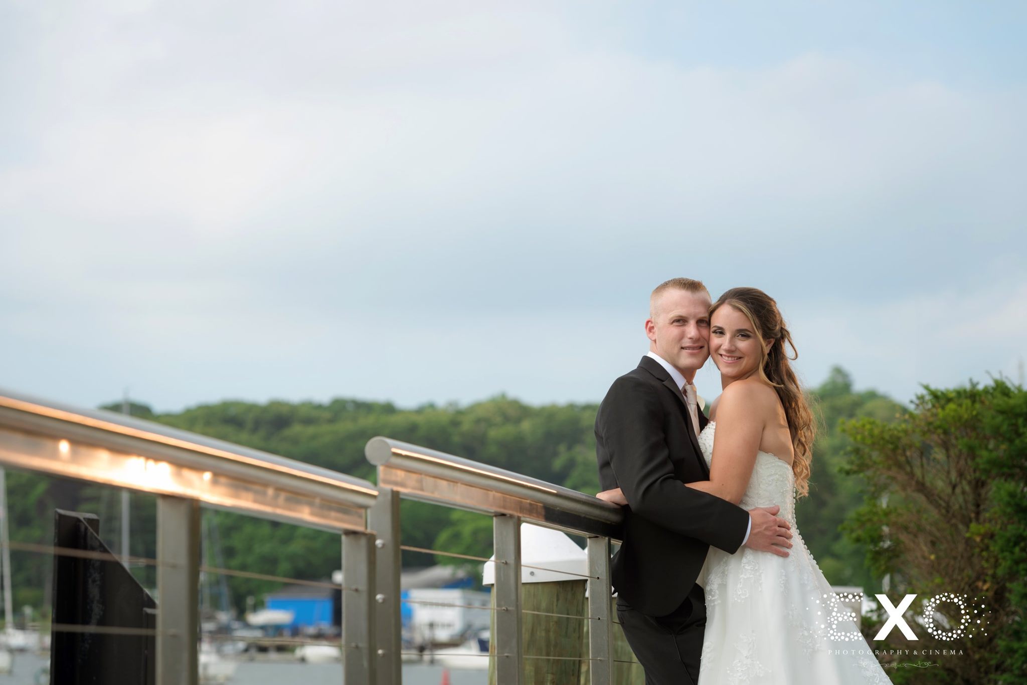 bride and groom on balcony at Harbor Club at Prime