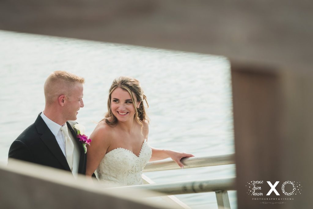 bride and groom on balcony at Harbor Club at Prime