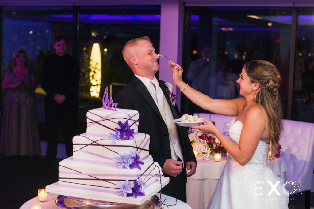 bride feeding the groom cake at Harbor Club at Prime