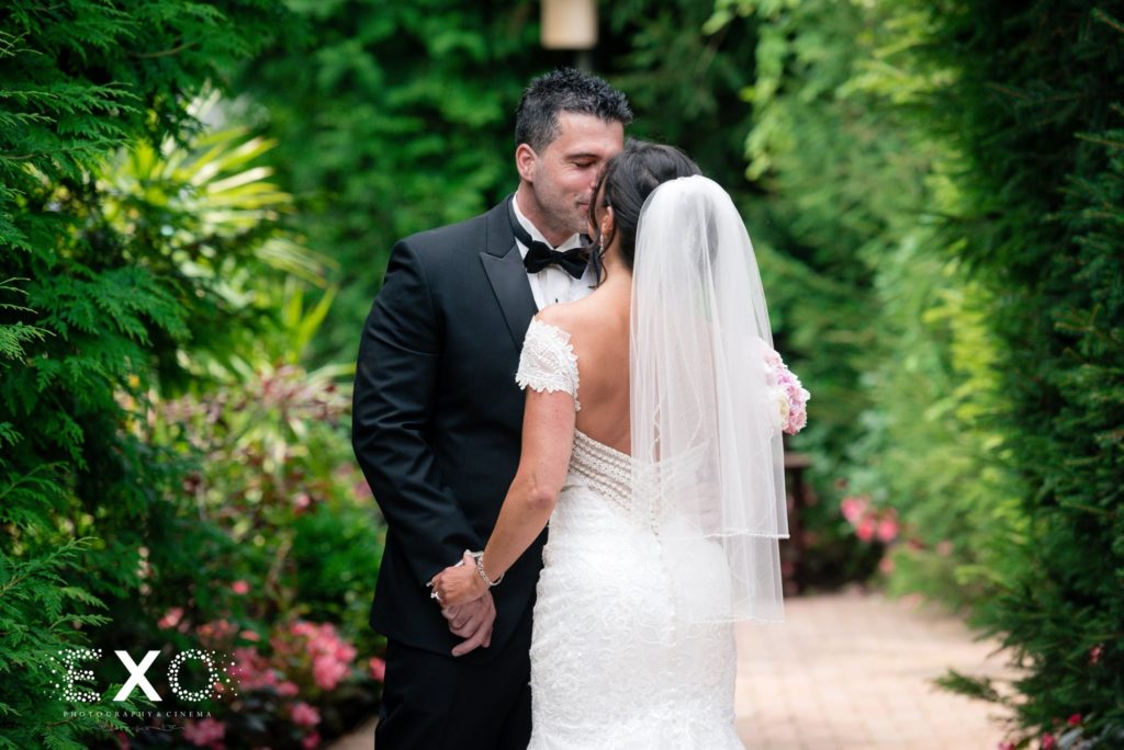 bride and groom kissing during first look at Crest Hollow Country Club