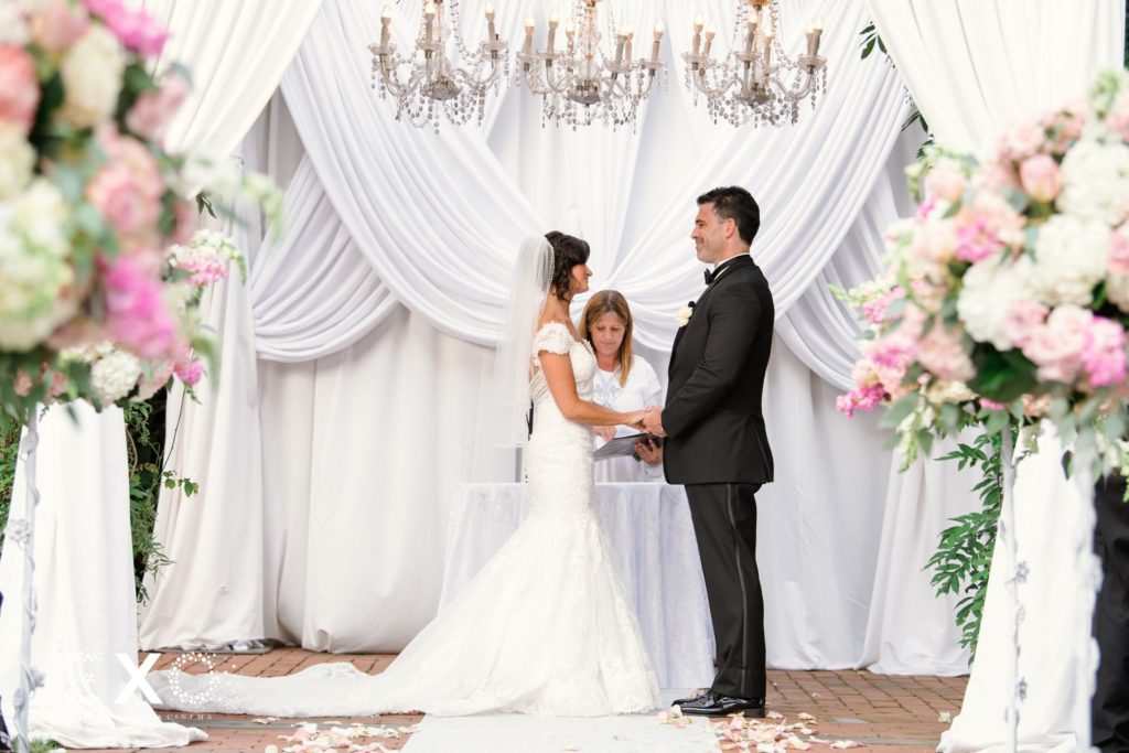 bride and groom exchanging vows at Crest Hollow Country Club