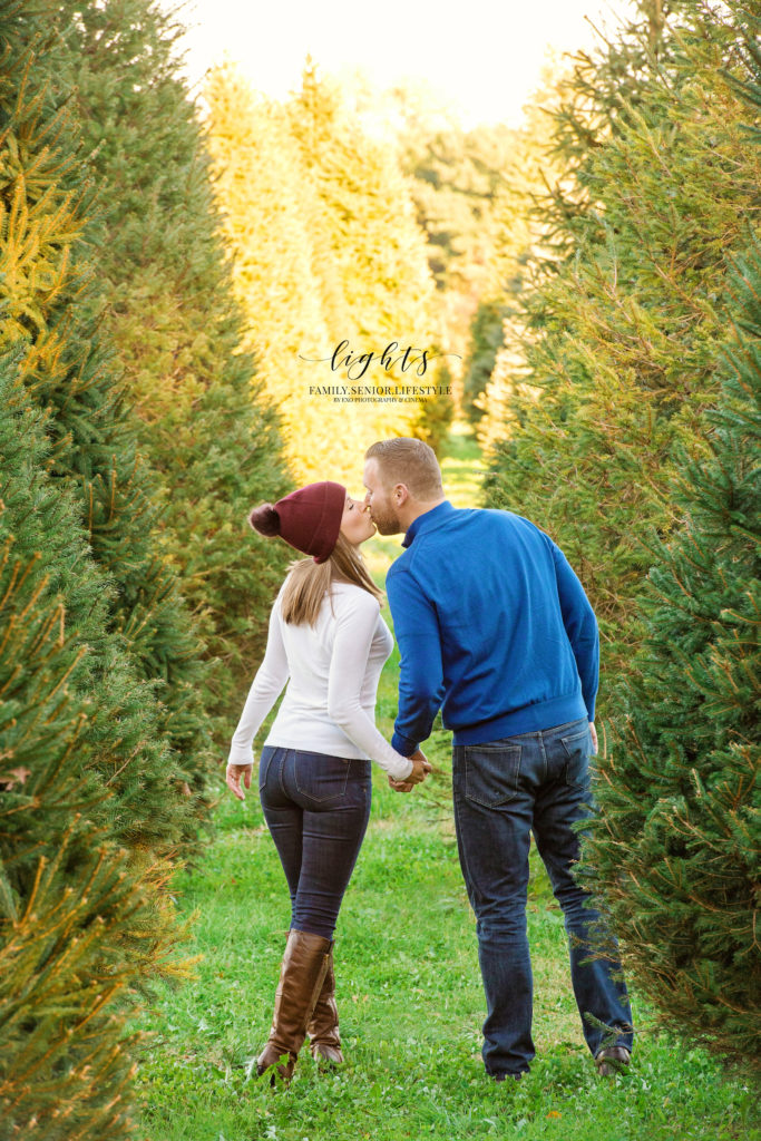 couple kissing with trees