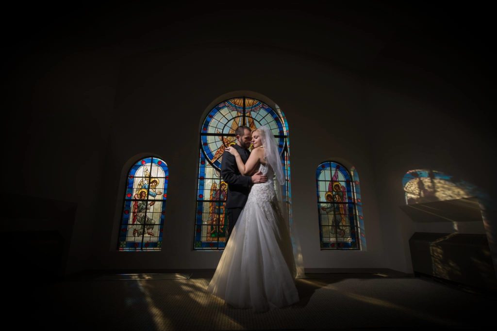 bride and groom in church window