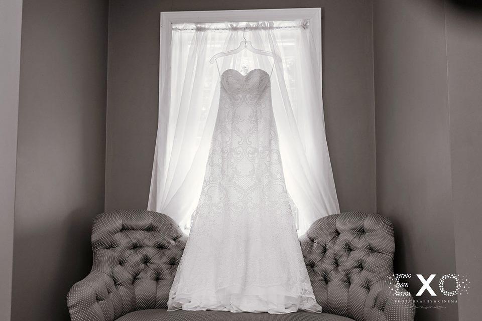 bride's wedding dress hanging in the window at The Head of the Bay Club