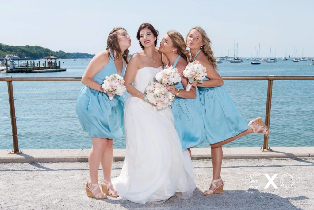 bride and her bridesmaids near the water at Willow Creek Golf and Country Club