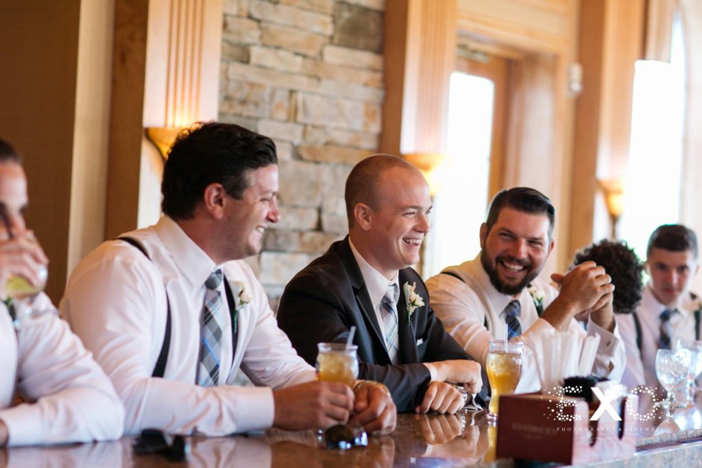 groom and groomsmen having a drink before the wedding