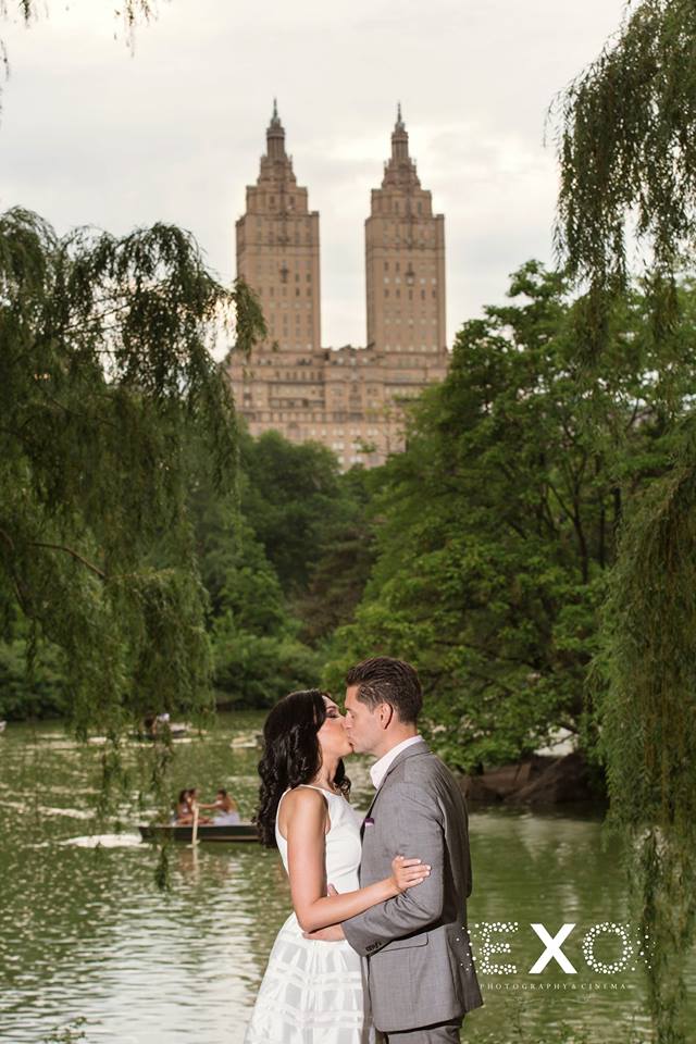 couple kissing by the water at Central Park
