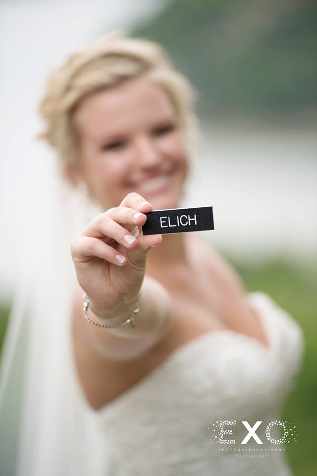 bride holding a plate with her new last name