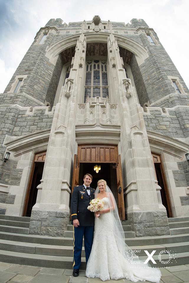bride and groom smiling outside church