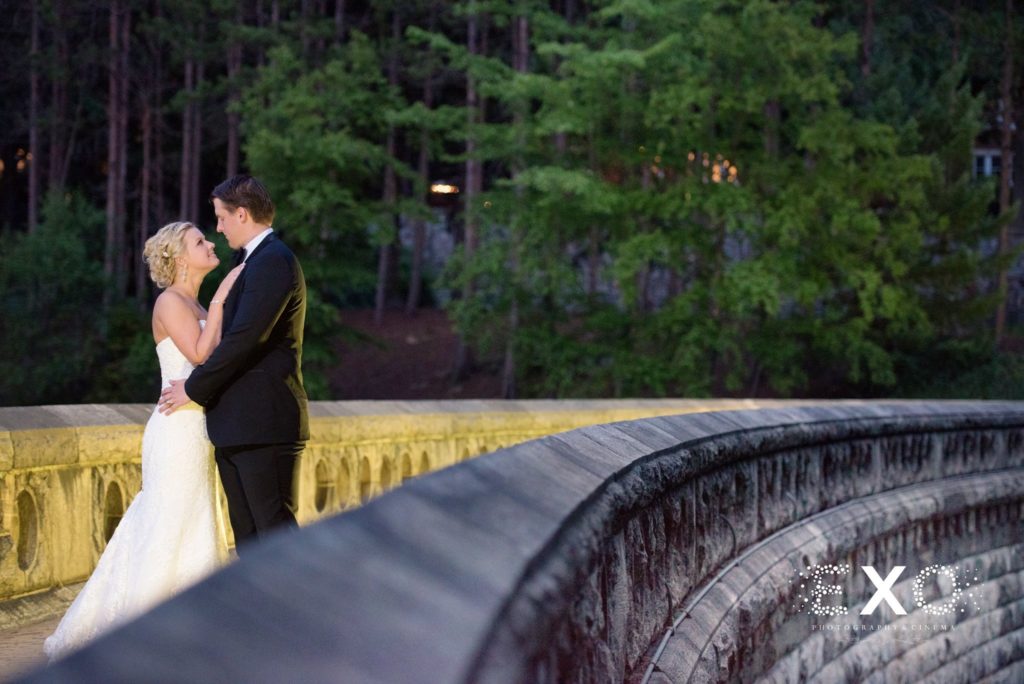 bride and groom on bridge at The Thayer Hotel at night
