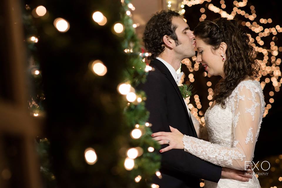 bride and groom among string lights at The Milleridge Cottage