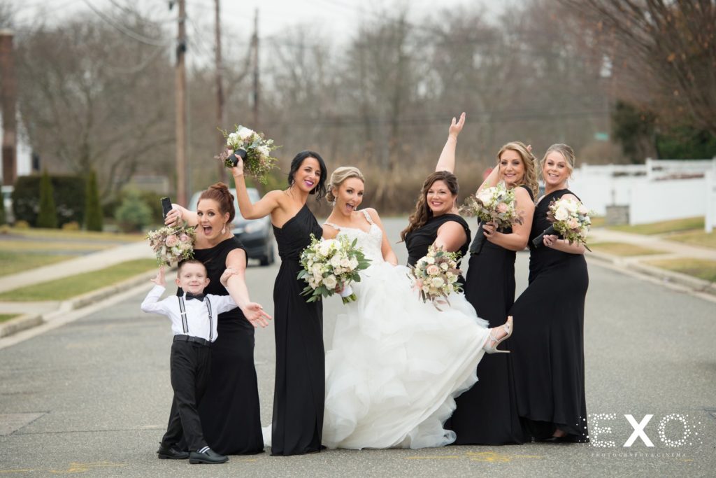 bride and her bridesmaids posing in the street