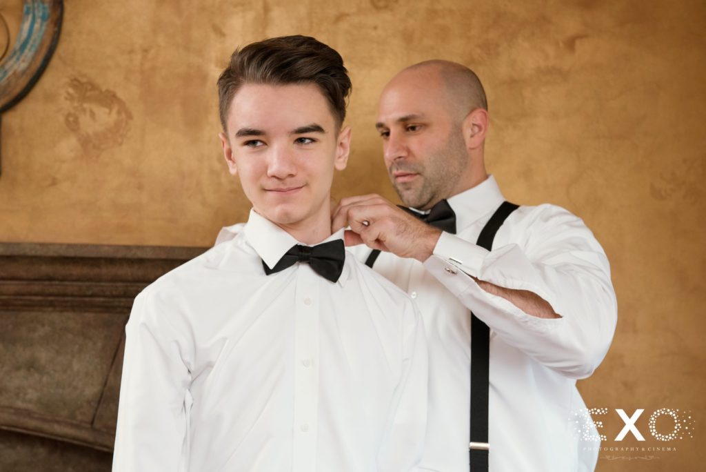 groom helping his step son with his bowtie