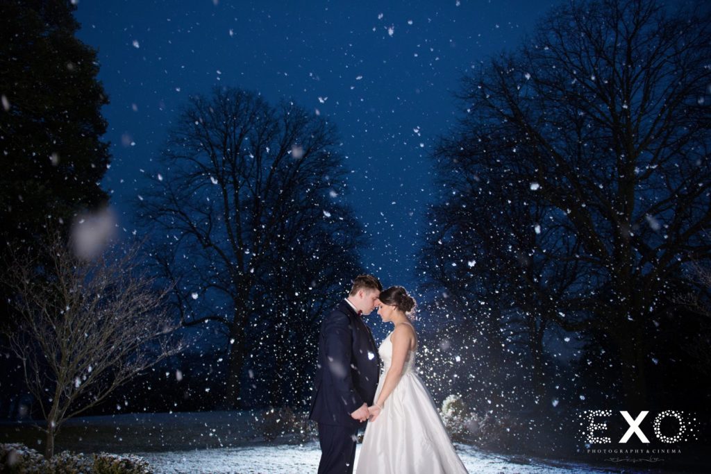 bride and groom outside The Mansion at Oyster Bay in the snow