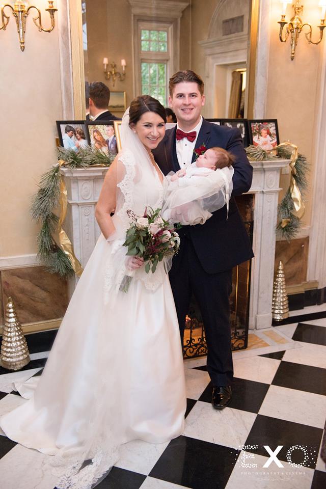 bride and groom holding baby at The Mansion at Oyster Bay
