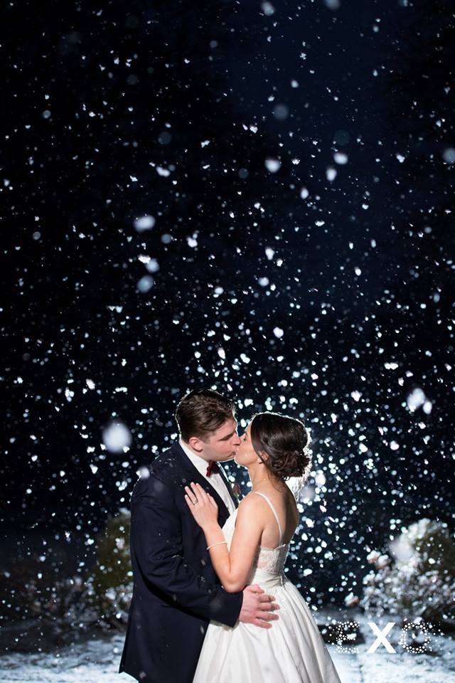 bride and groom kissing outside The Mansion at Oyster Bay in the snow