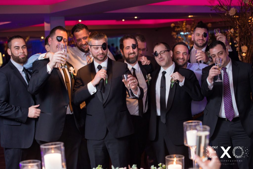 groomsmen in eye patches giving a toast at Harbor Club at Prime
