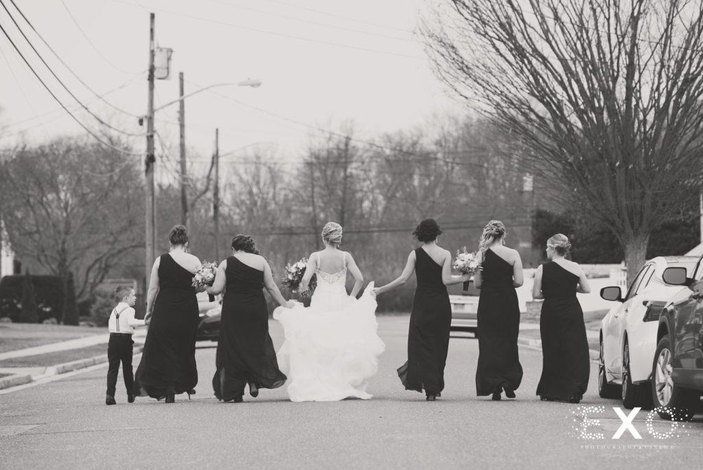 bride and bridesmaids walking down the street