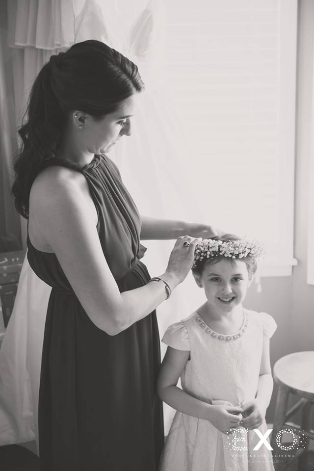 cute flower girl getting her flower crown put on for the The Mansion at Oyster Bay wedding