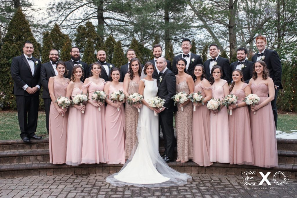 bride and groom with bridal party outside Temple Beth Torah