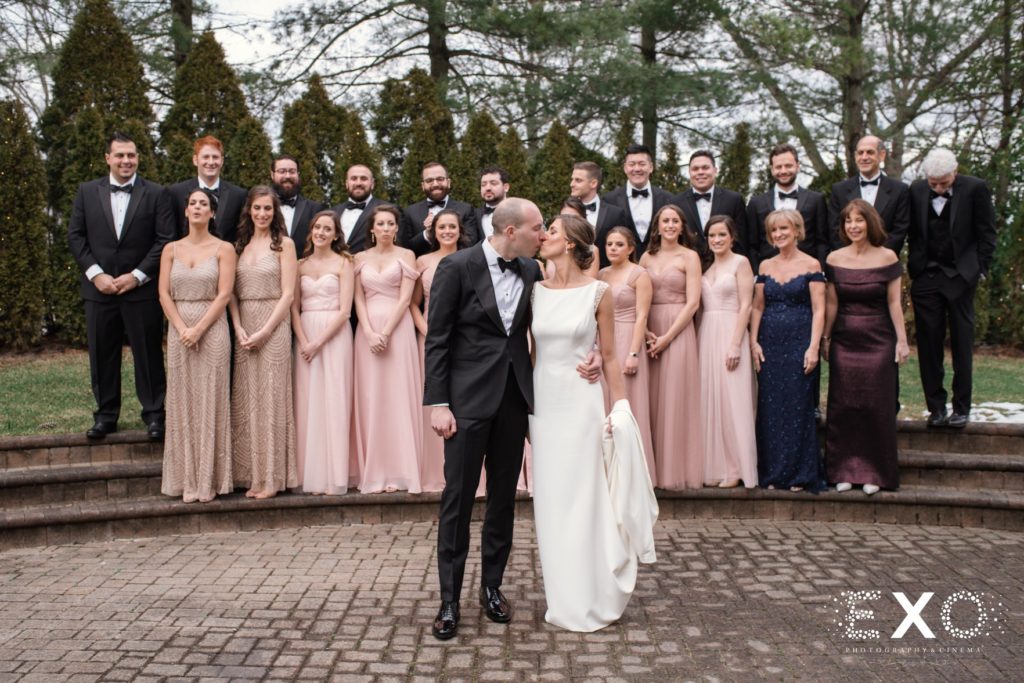 bride and groom with bridal party outside Temple Beth Torah