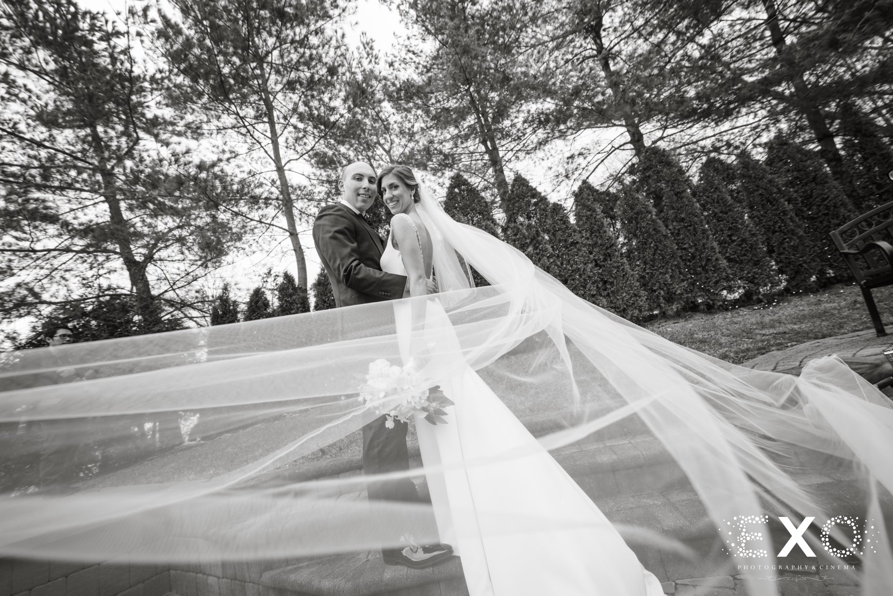 bride and groom with bride's veil blowing