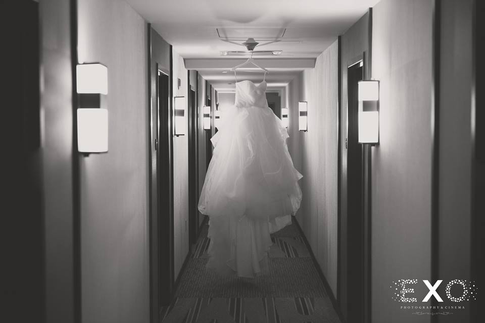 wedding dress hanging in hallway