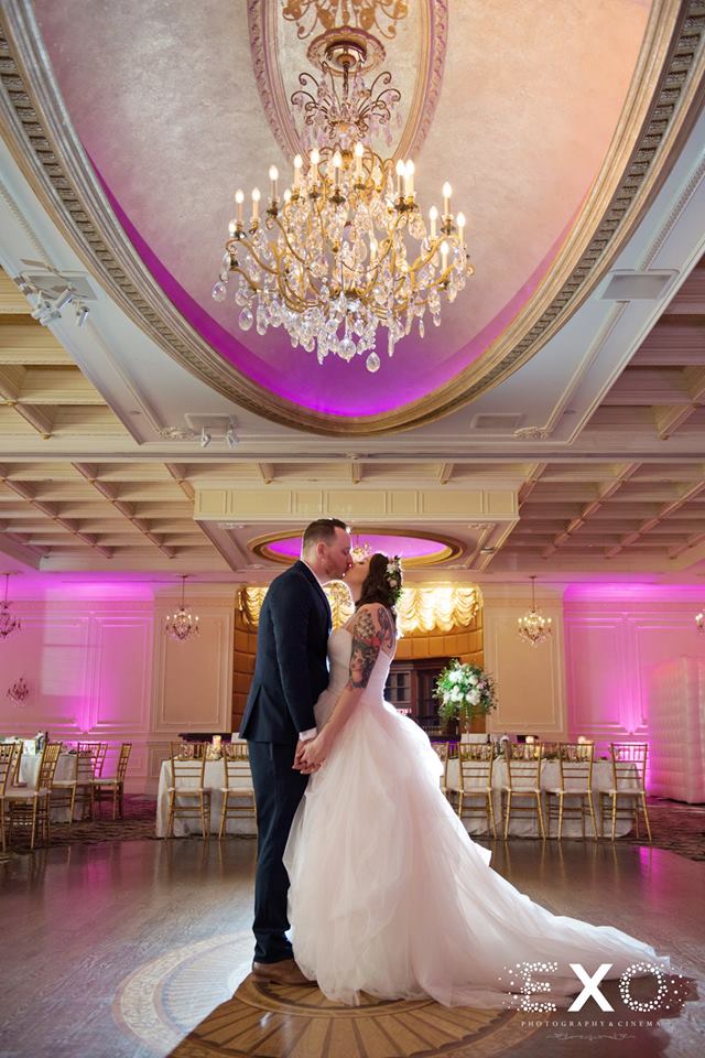 bride and groom kissing in ballroom at The Inn at New Hyde Park