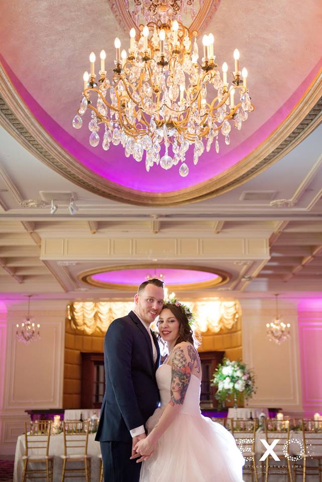 bride and groom smiling in the ballroom at The Inn at New Hyde Park