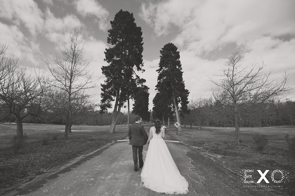bride and groom walking the grounds of Bourne Mansion